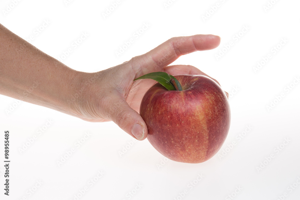 Girl hands holding a red apple over white Girl hands holding a red apple over white