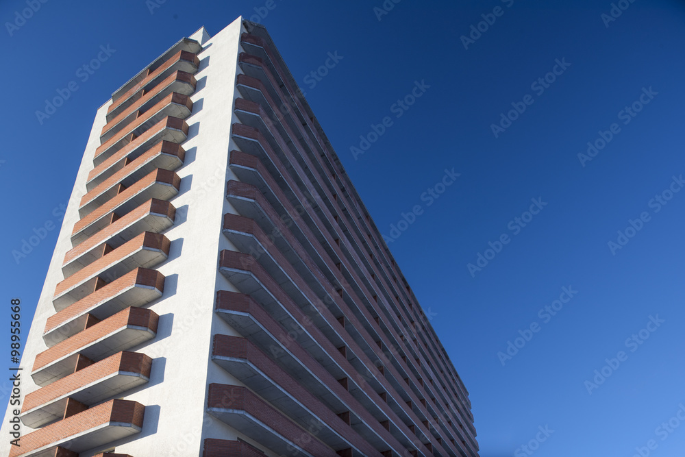 high residential building on a background of blue sky with tilt-shift effect
high residential building on a background of blue sky with tilt-shift effect