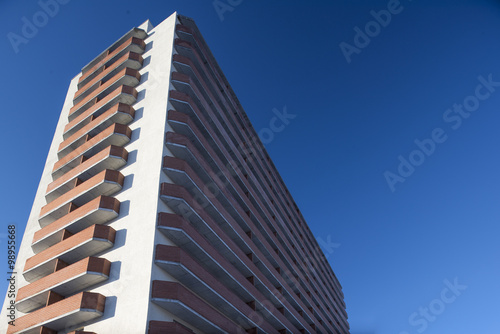 high residential building on a background of blue sky with tilt-shift effect  