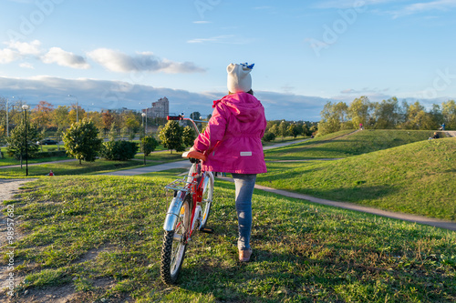 The girl in the red jacket with the bike