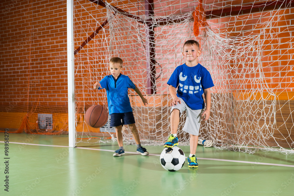 Two sporty young boys on an indoor court