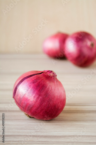 Red Onion on old wooden background