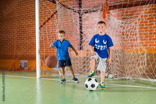 Obraz na płótnie Two sporty young boys on an indoor court w salonie