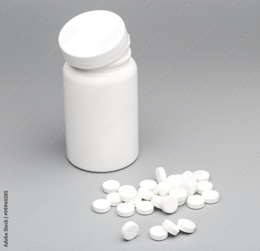 Round white tablet with the pill bottle Round white tablet with the pill bottle