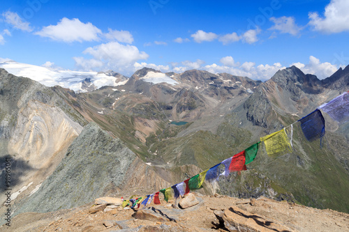 Panorama view with mountain Weißspitze, lake Eissee and Prayer flag in the Hohe Tauern Alps, Austria photo