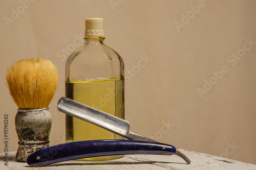 Photos sharp straight razor, brush and cologne aftershave