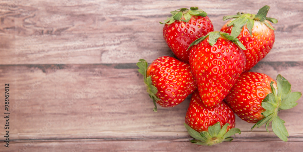 Plakat Strawberry fruit over wooden background
