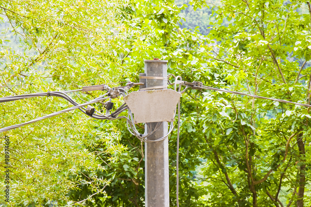 Italian metal telephone pole against a green background Italian metal telephone pole against a green background