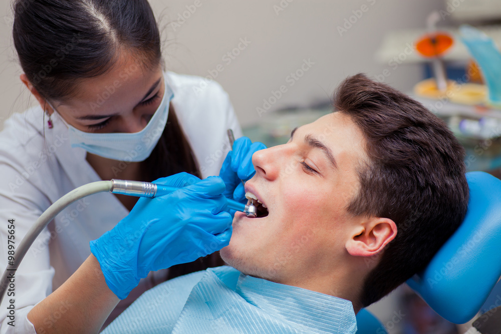 Man having teeth examined at dentists dental treatment Man having teeth examined at dentists dental treatment