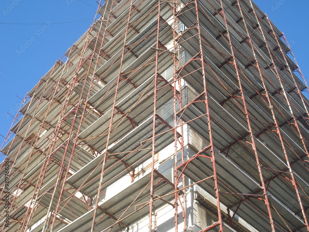 Scaffolds on block of apartments walls, for thermal insulating project