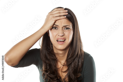 frustrated young woman on a white background