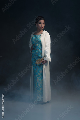 Stylish wealthy asian woman in retro forties fashion with handba