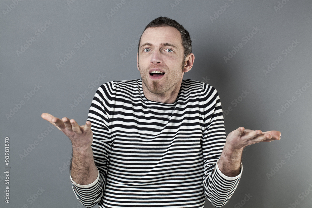 hand gesture concept - surprised 40s man holding or displaying something in empty hands in front of him,studio shot hand gesture concept - surprised 40s man holding or displaying something in empty hands in front of him,studio shot