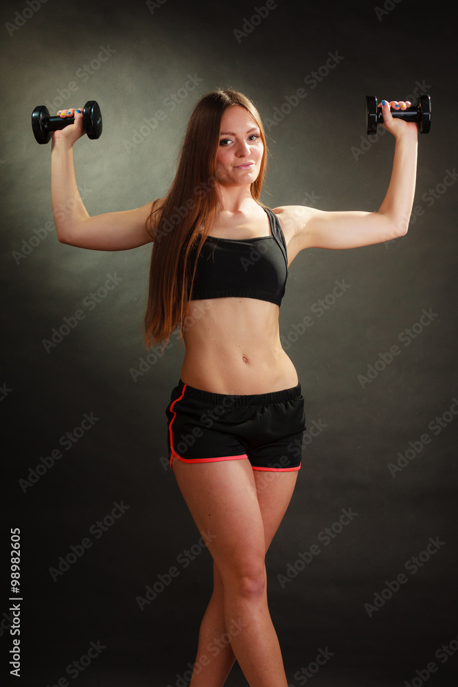 Fit woman exercising with dumbbells. Fit woman exercising with dumbbells.