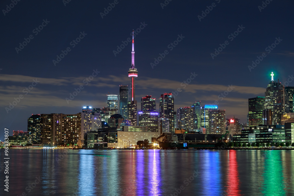 amazing stunning gorgeous beautiful night view of Toronto city downtown from lake Ontario with colorful light reflections in water