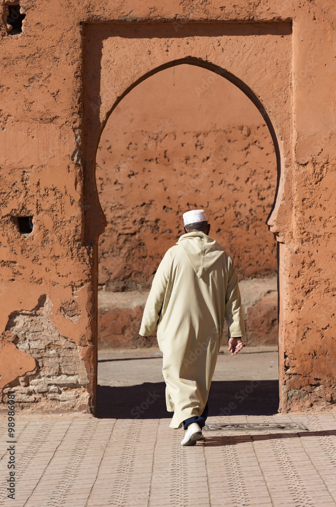 Old man entering a doorway in Morocco