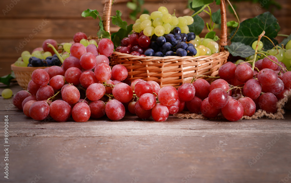 Grape in basket on wooden table Grape in basket on wooden table