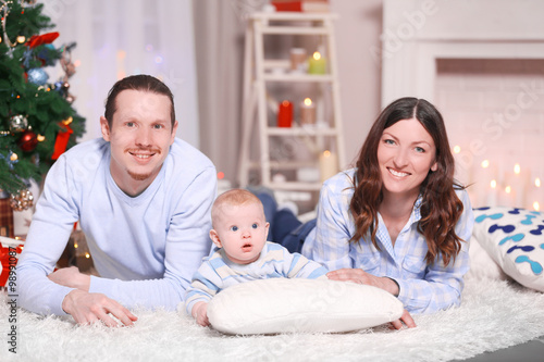 Happy family with baby lyin...