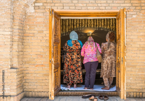 Uzbekistan, Samarkand, local faithful in prayer in the St Daniel mausoleum