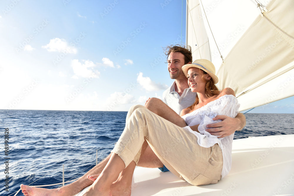 Romantic couple enjoying sail cruise on Caribbean sea Romantic couple enjoying sail cruise on Caribbean sea