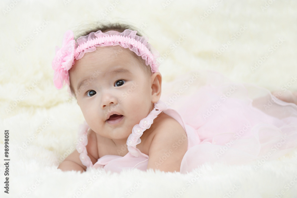 Baby sitting on a soft cloth in the living room Baby sitting on a soft cloth in the living room