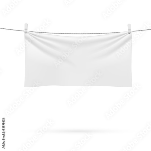 A beach towel hanging on a rope isolated on a white background.