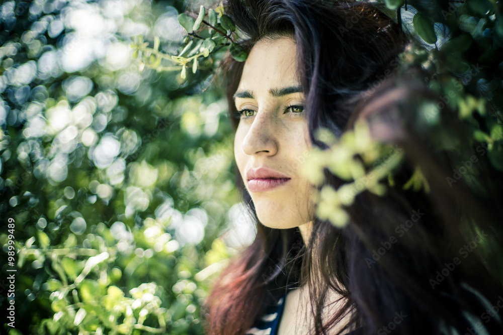 freedom, romantic girl with branches of a tree in a park freedom, romantic girl with branches of a tree in a park