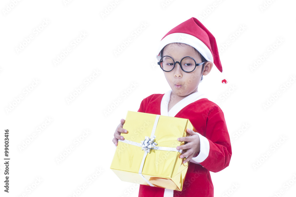 Little boy wearing Santa Claus uniform with a gift Little boy wearing Santa Claus uniform with a gift