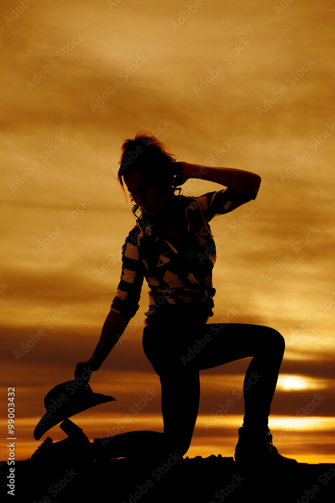 silhouette of woman on one knee look back