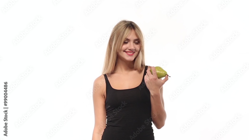 Beauty woman smiling and biting sweet pear