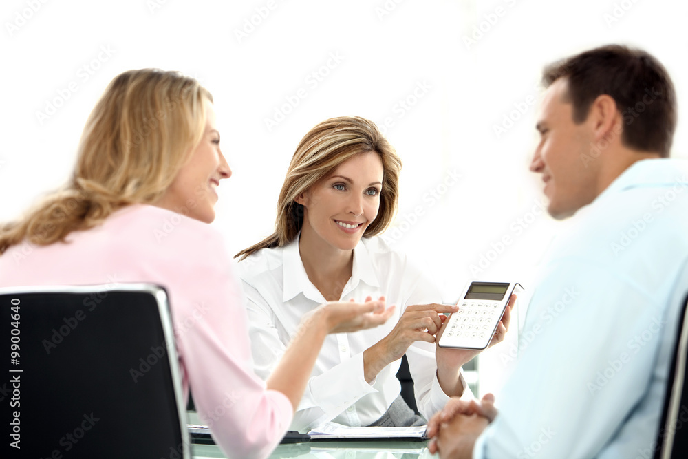 Time for a Financial Decision - Smiling man and woman ready to accept financial offer. Attractive Female Financial Adviser showing result on calculator. Time for a Financial Decision - Smiling man and woman ready to accept financial offer. Attractive Female Financial Adviser showing result on calculator.