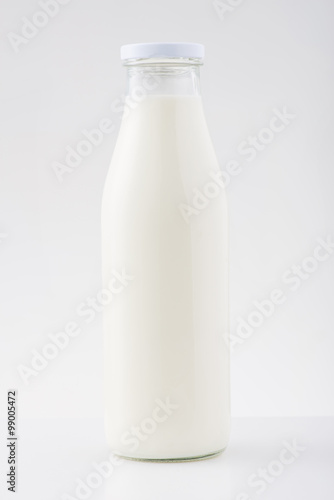 Medium bottle of milk is on the surface.