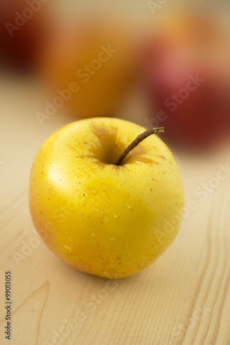 Delicious and fresh apple on wood and blur background