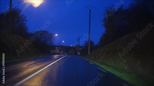 Fahrt mit dem PKW über eine Landstraße in der blauen Stunde  photo