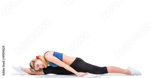 Attractive fit woman exercising in studio with copyspace. Image of healthy young female athlete doing fitness workout against grey background.