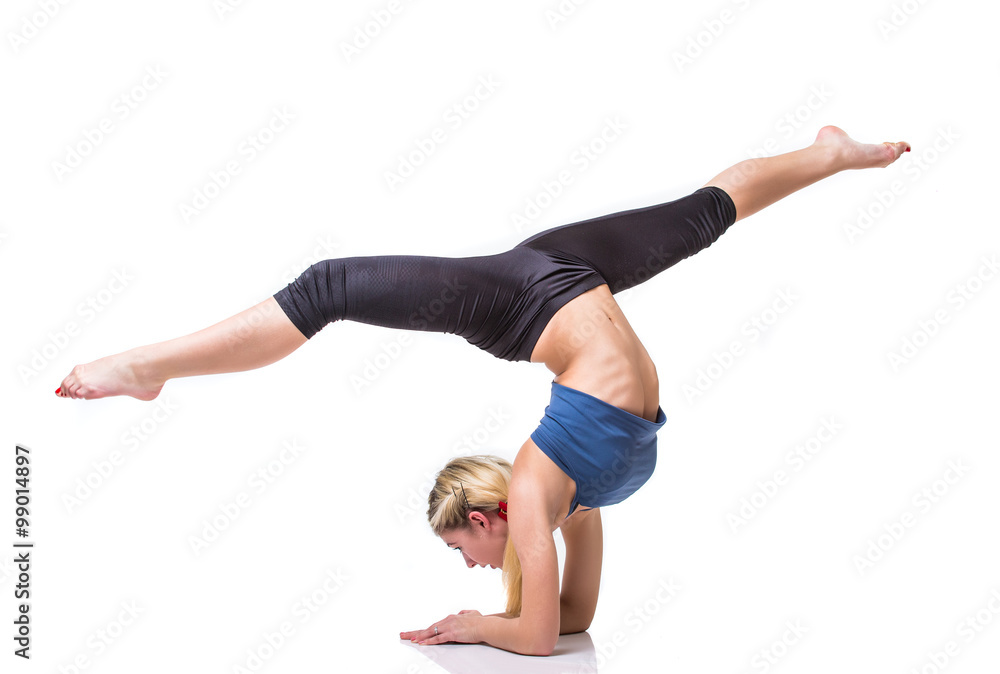 Attractive fit woman exercising in studio with copyspace. Image of healthy young female athlete doing fitness workout against grey background with poor light Attractive fit woman exercising in studio with copyspace. Image of healthy young female athlete doing fitness workout against grey background with poor light