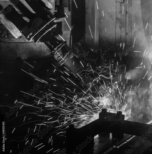 Welding robots movement in a car factory black white