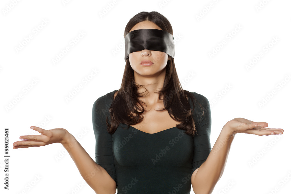 confused blindfolded woman on a white background Stock Photo