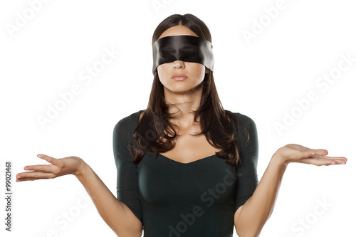 confused blindfolded woman on a white background