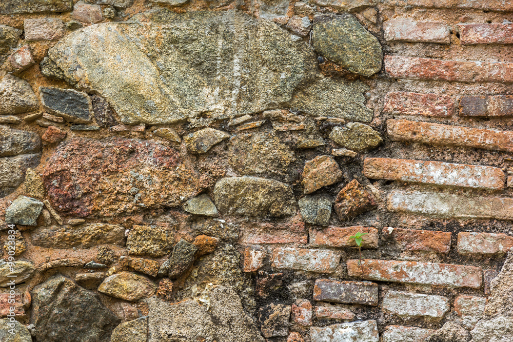 Fundo de parede antiga com pedras e tijolos.
