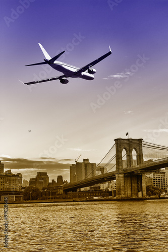 Plane in landing over Brooklyn Bridge