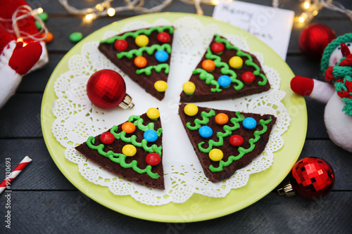 Delicious colorful Christmas cookies on plate with festive decoration