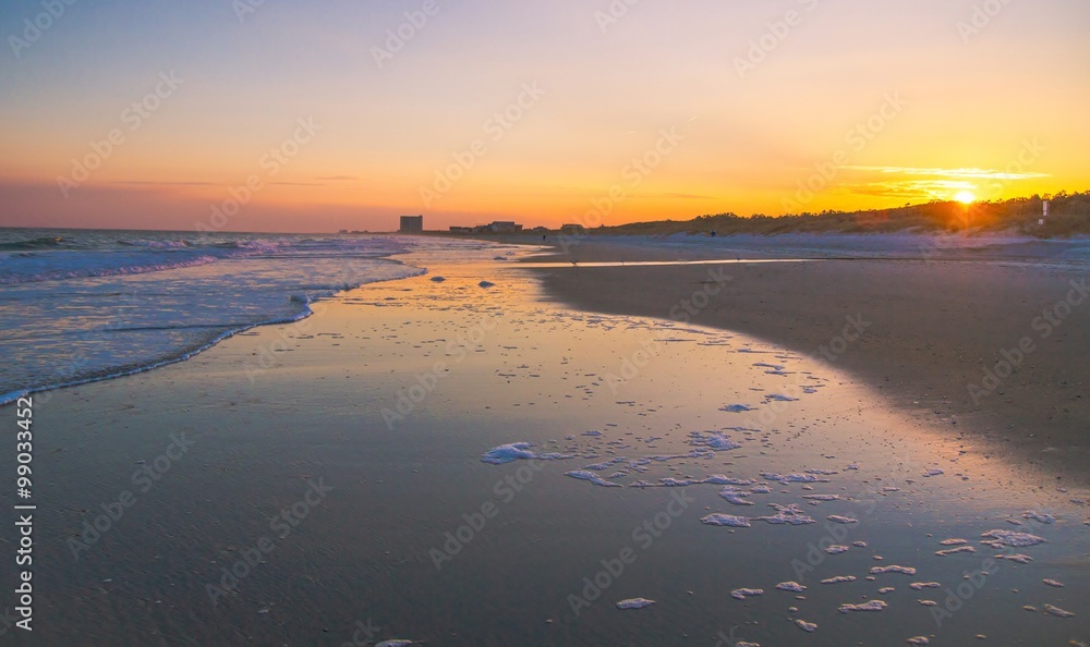 Myrtle Beach Sunset. Sunset on a wide Atlantic Ocean beach with the popular resort town of Myrtle Beach, South Carolina in the background.