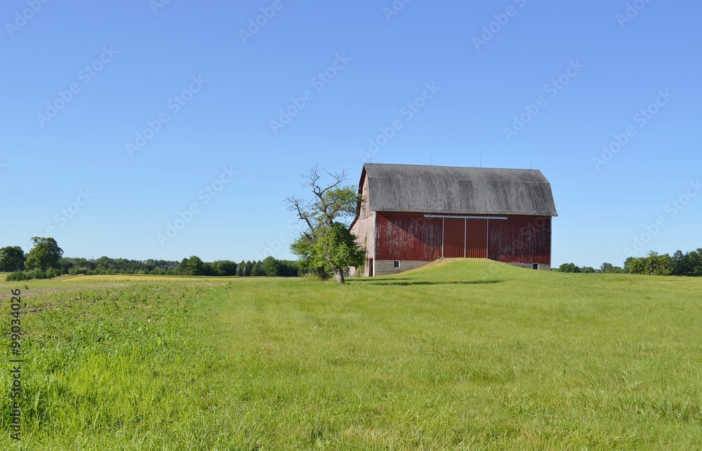 Agriculture storage barn and surrounding farmland on a sunny summer day Agriculture storage barn and surrounding farmland on a sunny summer day