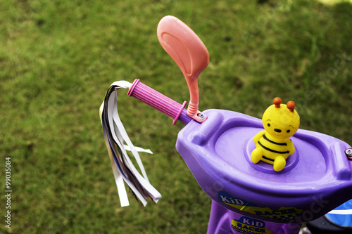 a toddler tricyle with squakey toy on blurred background. image contained small depth of field photo