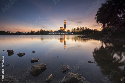 Perfect reflection of a floating mosque Masjid Tengku Tengah Zaharah in Kuala Ibai, Terengganu, Malaysia during sunset photo