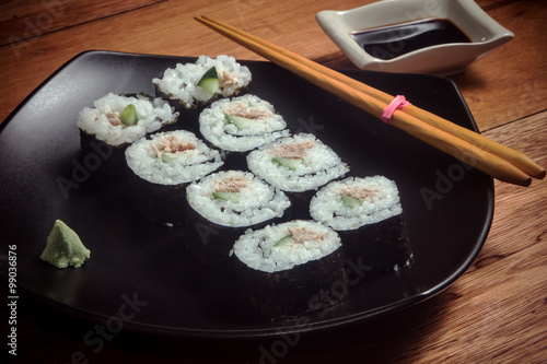 Japanese roll with tuna and cucumber on the black plate