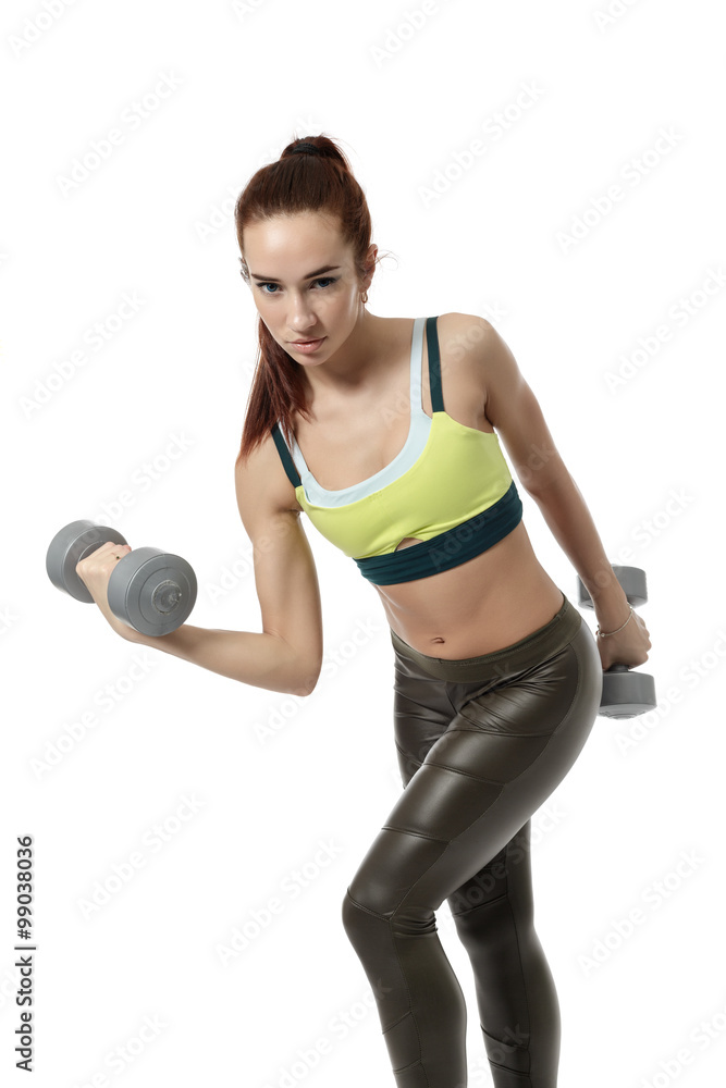 Beautiful blue-eyed girl training with dumbbells Beautiful blue-eyed girl training with dumbbells