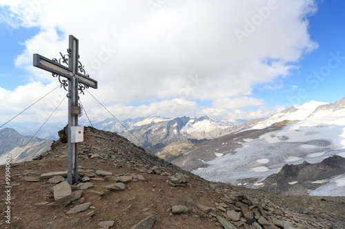 Summit cross on mountain Weißspitze with Großvenediger panorama in Hohe Tauern Alps, Austria