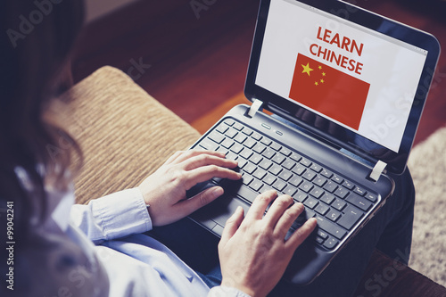 Female learning chinese at home with a computer laptop.